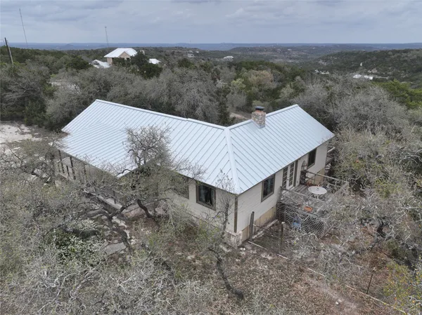 a view of a house with a yard and mountain view