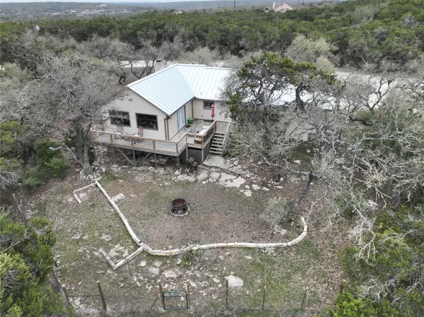 an aerial view of a house with a yard