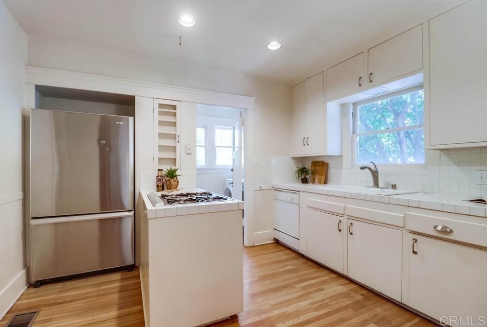 1944 Granada Avenue San Diego, CA 92102 - Photo 25 of 65 a kitchen with a refrigerator and a sink