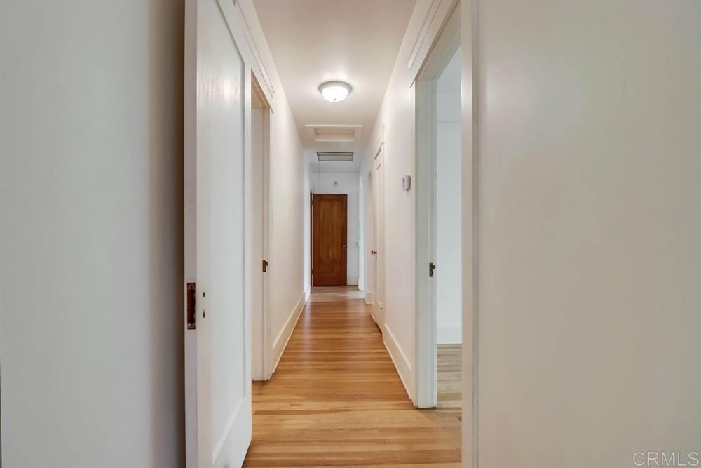 1944 Granada Avenue San Diego, CA 92102 - Photo 34 of 65 a view of a hallway with wooden floor and a bathroom