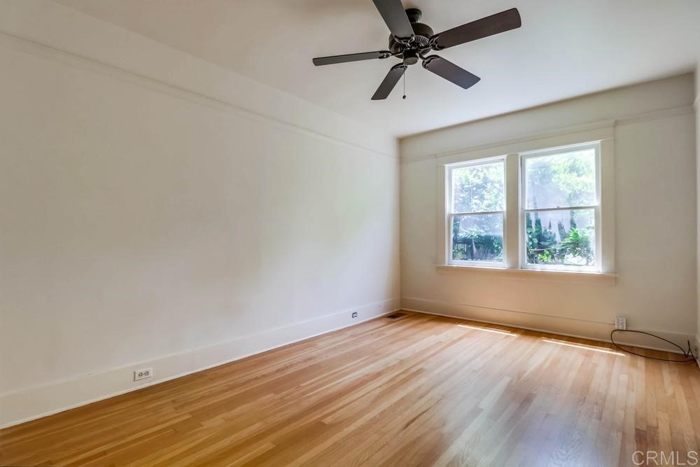 1944 Granada Avenue San Diego, CA 92102 - Photo 41 of 65 an empty room with wooden floor fan and windows