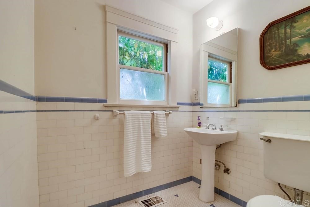 1944 Granada Avenue San Diego, CA 92102 - Photo 43 of 65 a bathroom with a sink a toilet and a mirror
