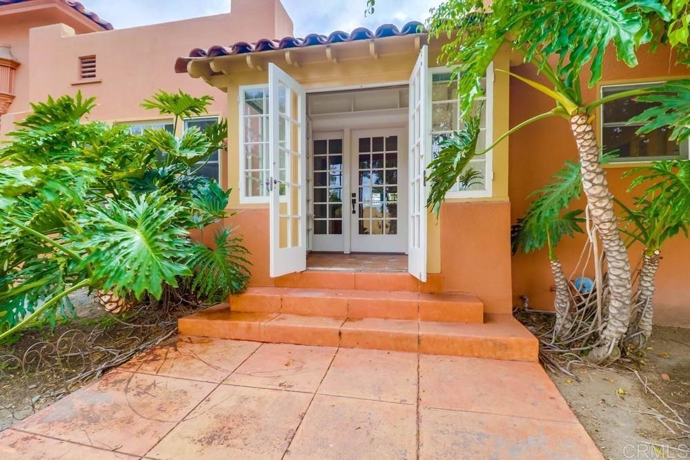 1944 Granada Avenue San Diego, CA 92102 - Photo 49 of 65 a backyard of a house with potted plants and palm trees