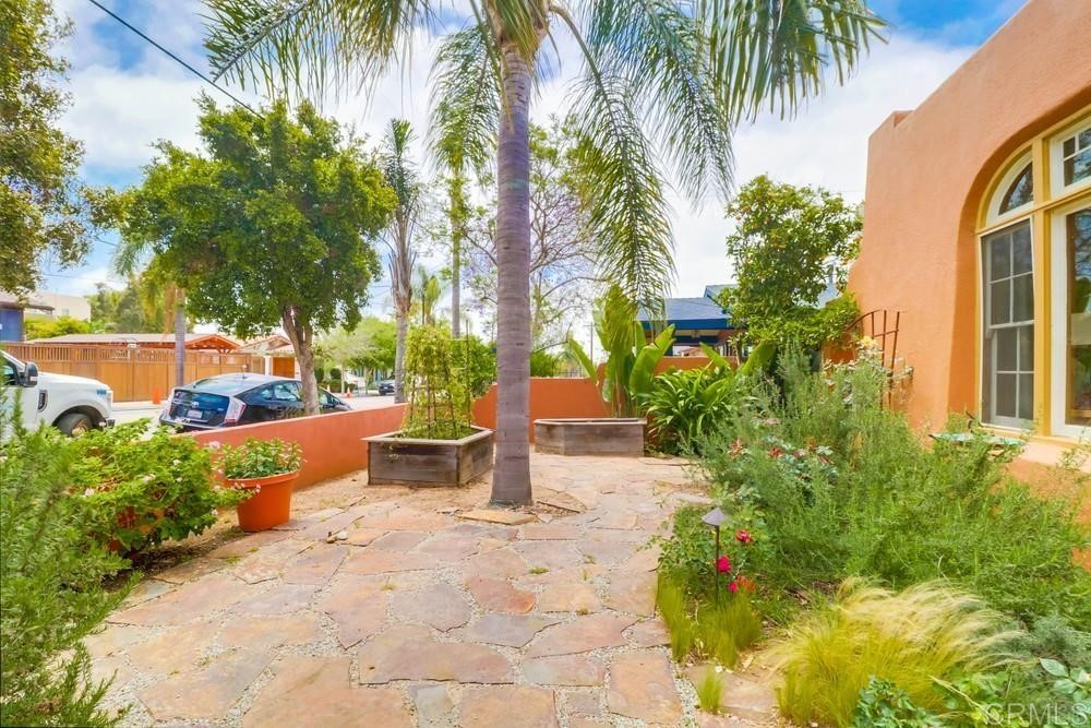 1944 Granada Avenue San Diego, CA 92102 - Photo 9 of 65 a view of a backyard with potted plants and large trees