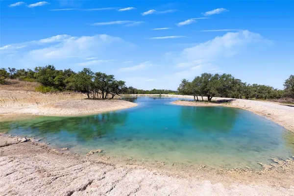 a view of a lake with houses in the background