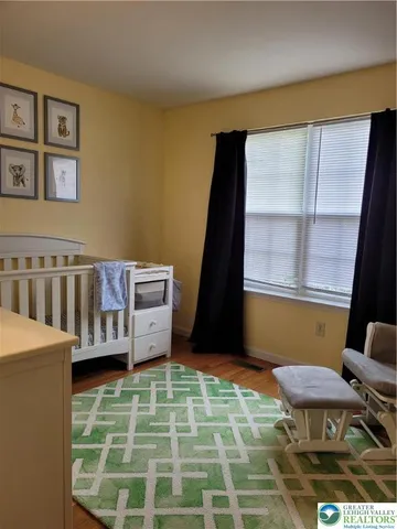 a view of a bedroom with furniture and window