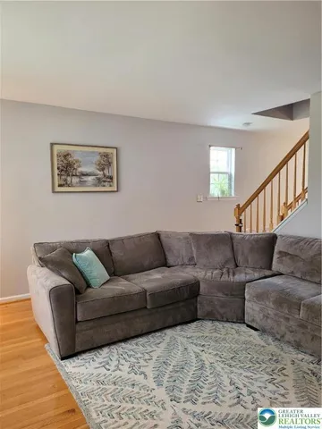 a living room with furniture and a rug