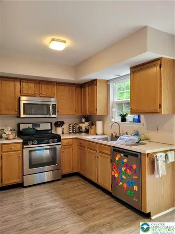 a kitchen with stainless steel appliances granite countertop a stove and a sink
