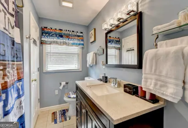 a bedroom with two beds and a chandelier