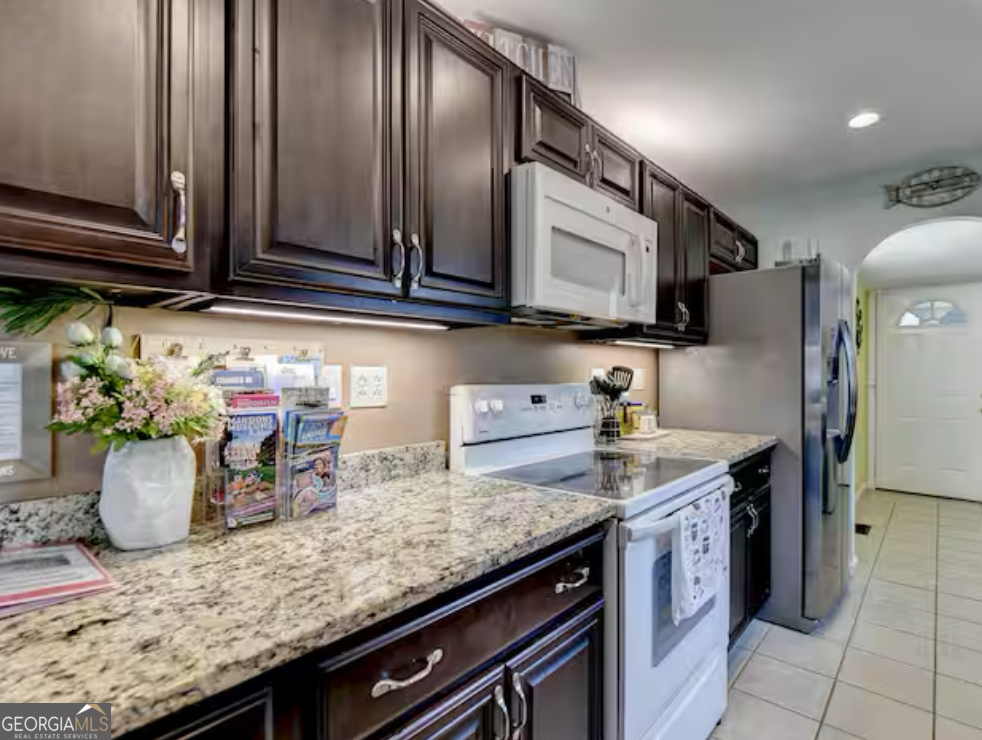 2817 Evergreen Place Gainesville, GA 30501 - Photo 7 of 27 a kitchen with stainless steel appliances granite countertop a sink stove and cabinets