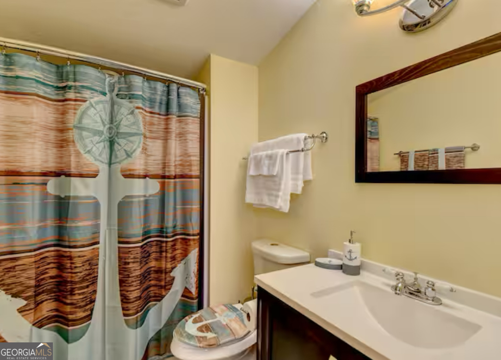 2817 Evergreen Place Gainesville, GA 30501 - Photo 10 of 27 a bathroom with a sink and a mirror