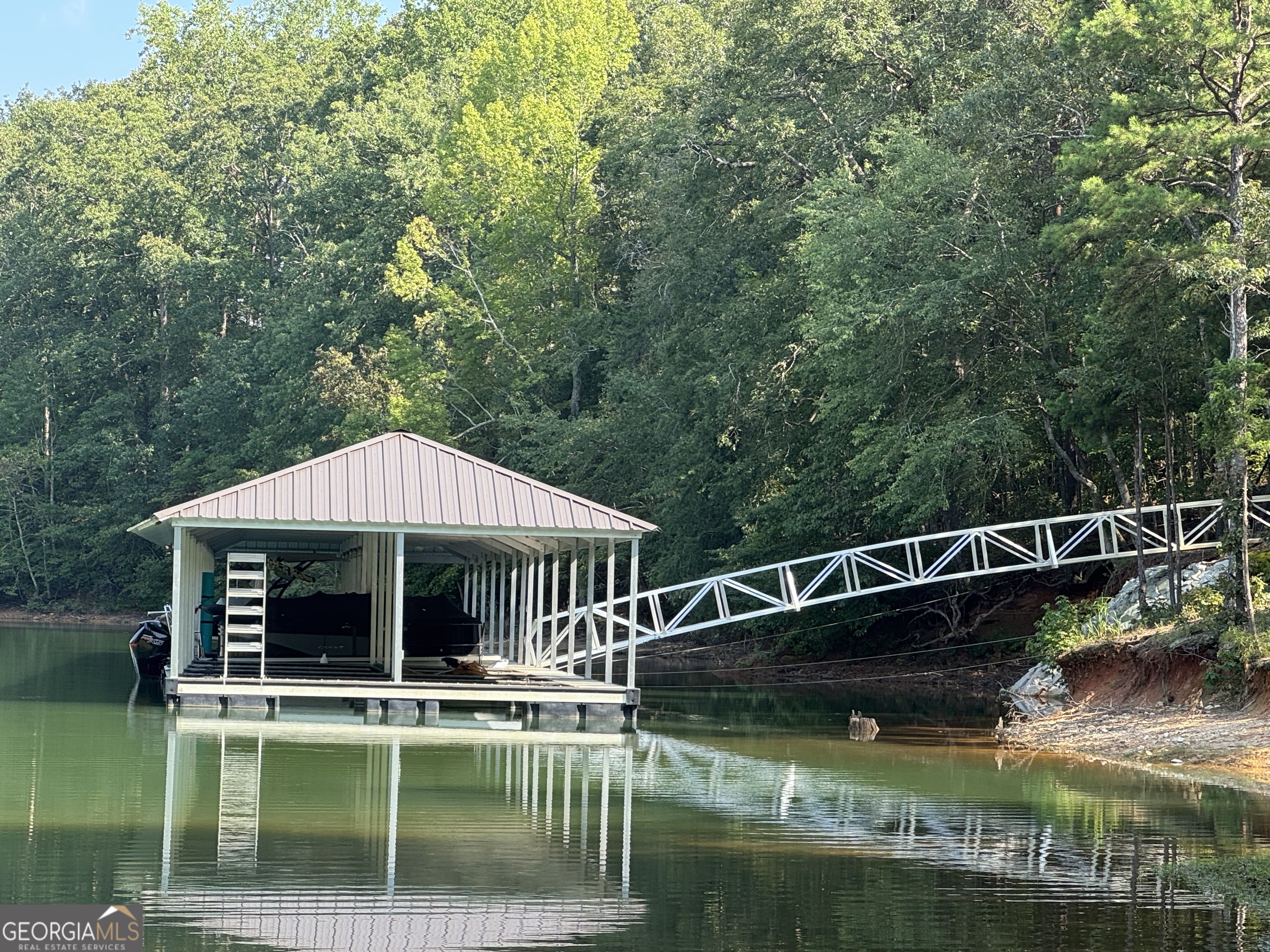 a view of house with swimming pool and outdoor seating