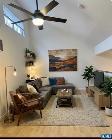 a living room with furniture and a potted plant