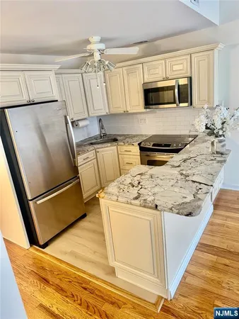 a kitchen with a stove a refrigerator and a sink