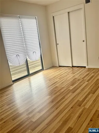 a view of a room with wooden floor and stairs