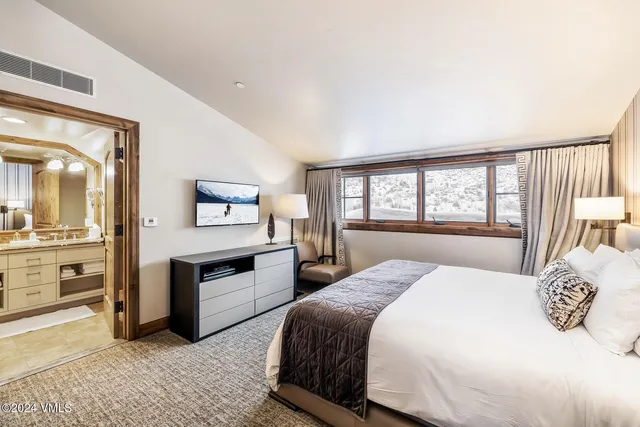 a living room with lots of furniture and a large window