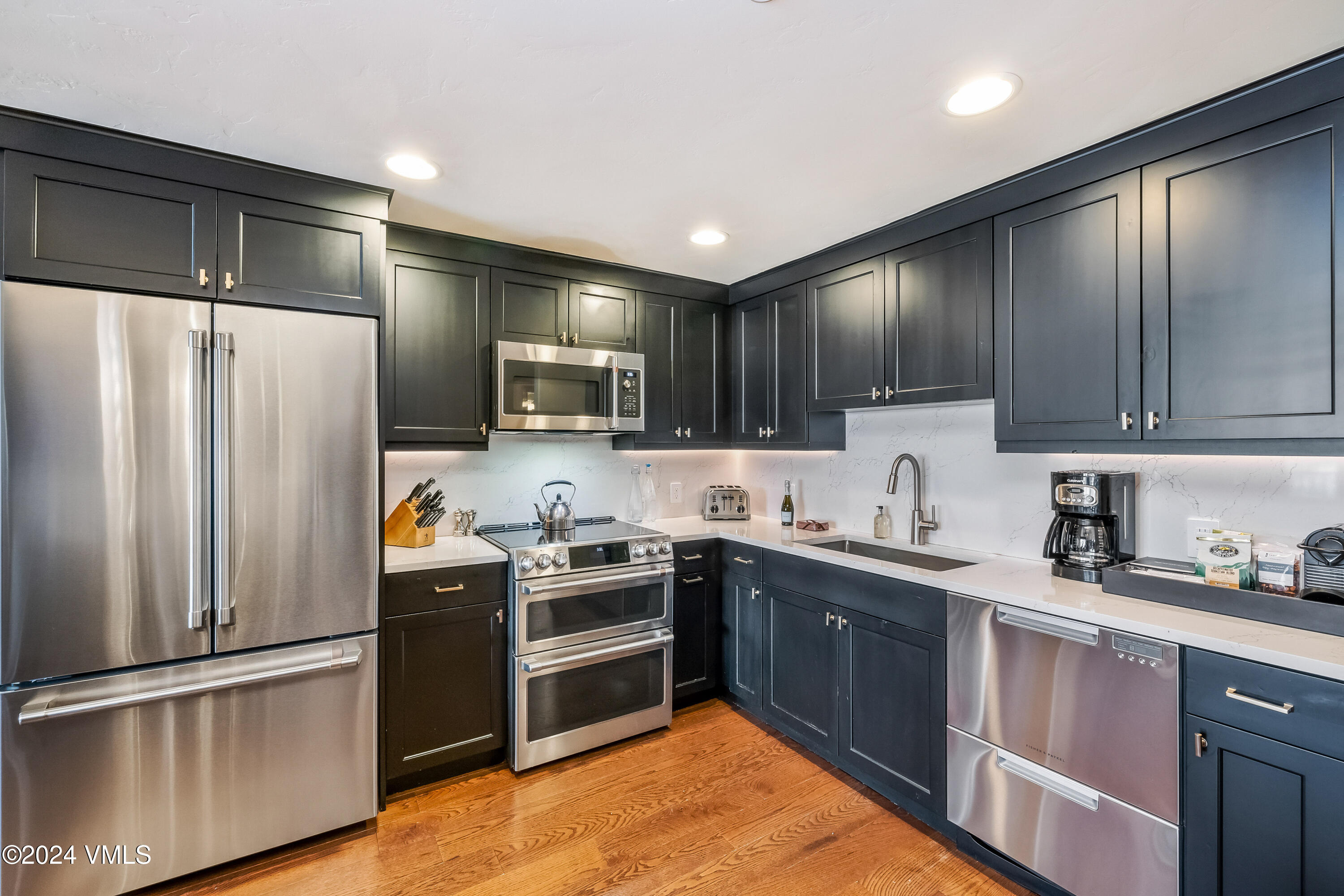 16 Vail Road Vail, CO 81657 - Photo 16 of 36 a kitchen with stainless steel appliances granite countertop a refrigerator sink and microwave