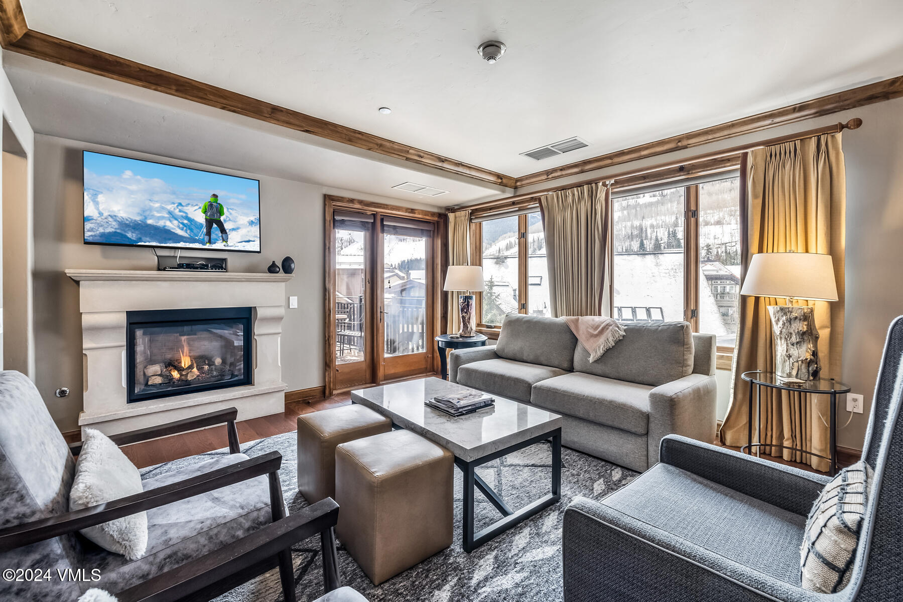 16 Vail Road Vail, CO 81657 - Photo 17 of 36 a living room with furniture a flat screen tv and a fireplace