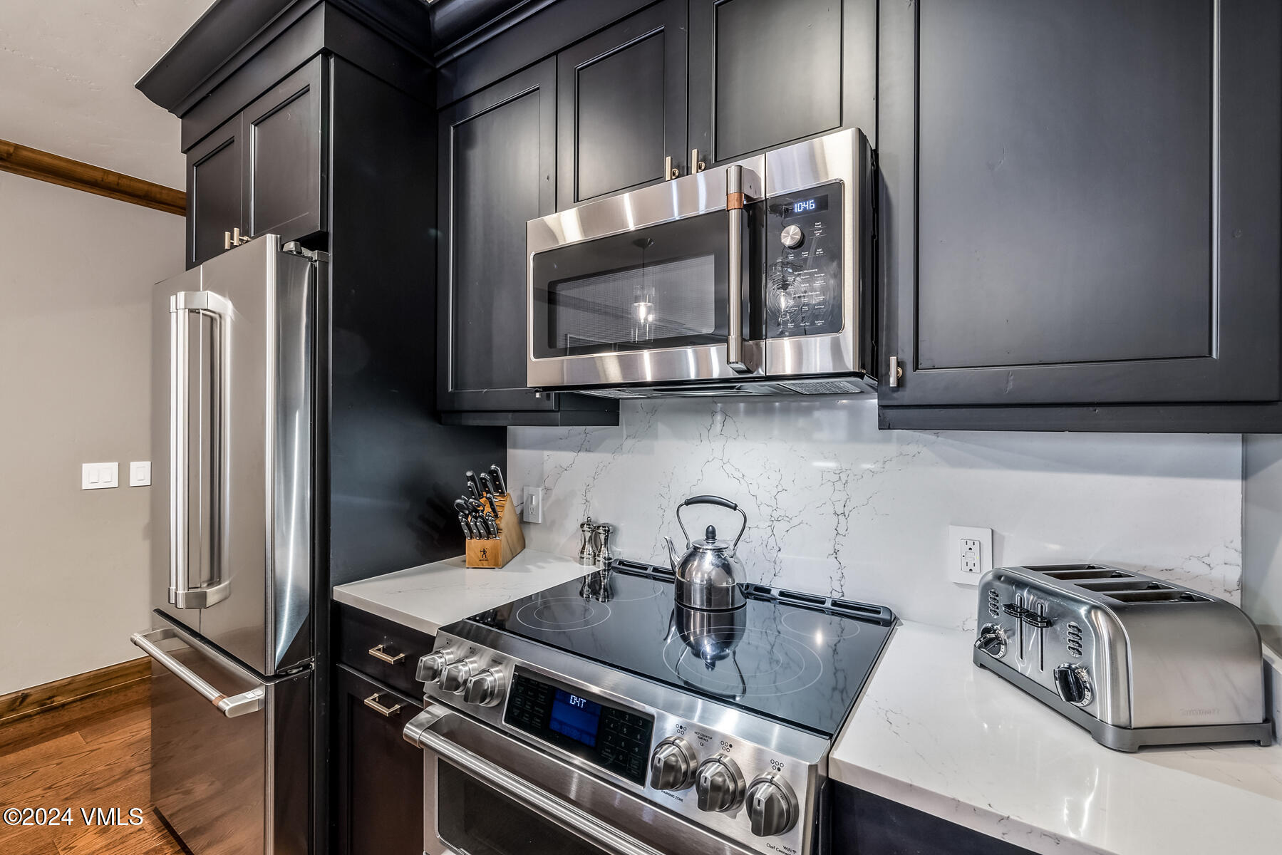 16 Vail Road Vail, CO 81657 - Photo 19 of 36 a kitchen with stainless steel appliances granite countertop a sink stove and refrigerator