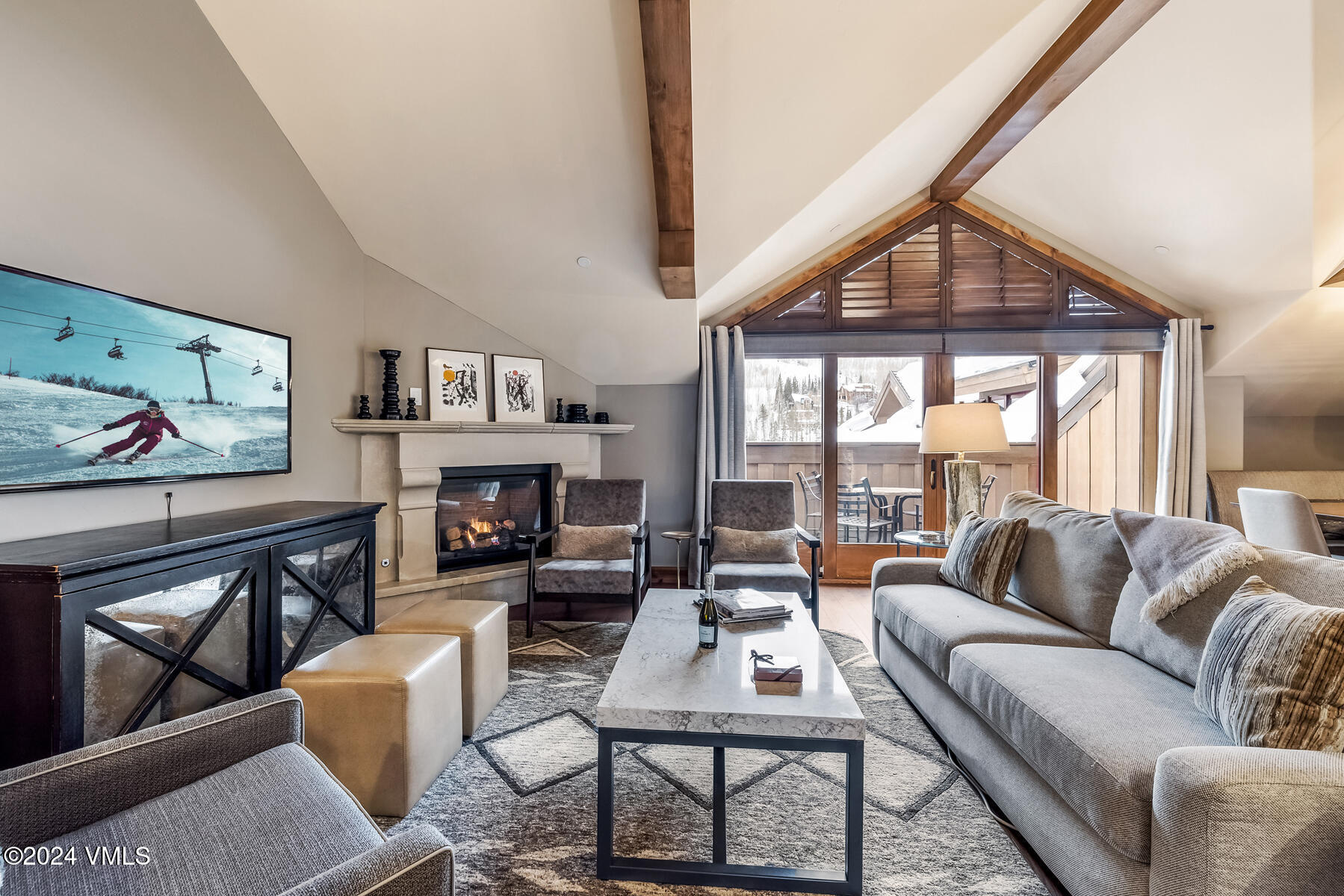 16 Vail Road Vail, CO 81657 - Photo 21 of 36 a living room with furniture a fireplace and a large window
