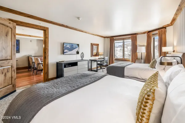 a spacious bedroom with a large bed and a large window