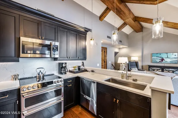 a living room with fireplace furniture and a wooden floor