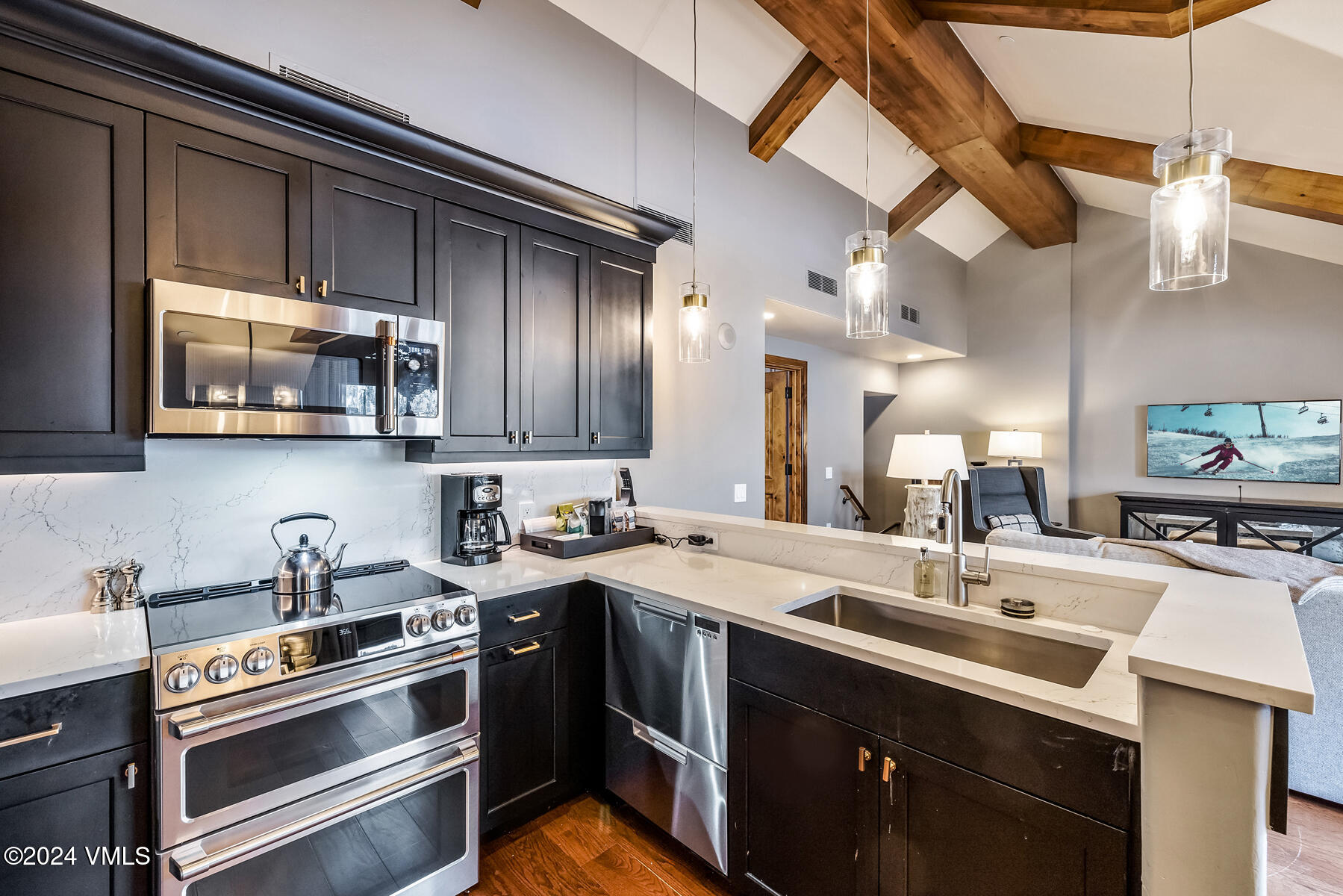 16 Vail Road Vail, CO 81657 - Photo 9 of 36 a kitchen with stainless steel appliances a sink stove and cabinets