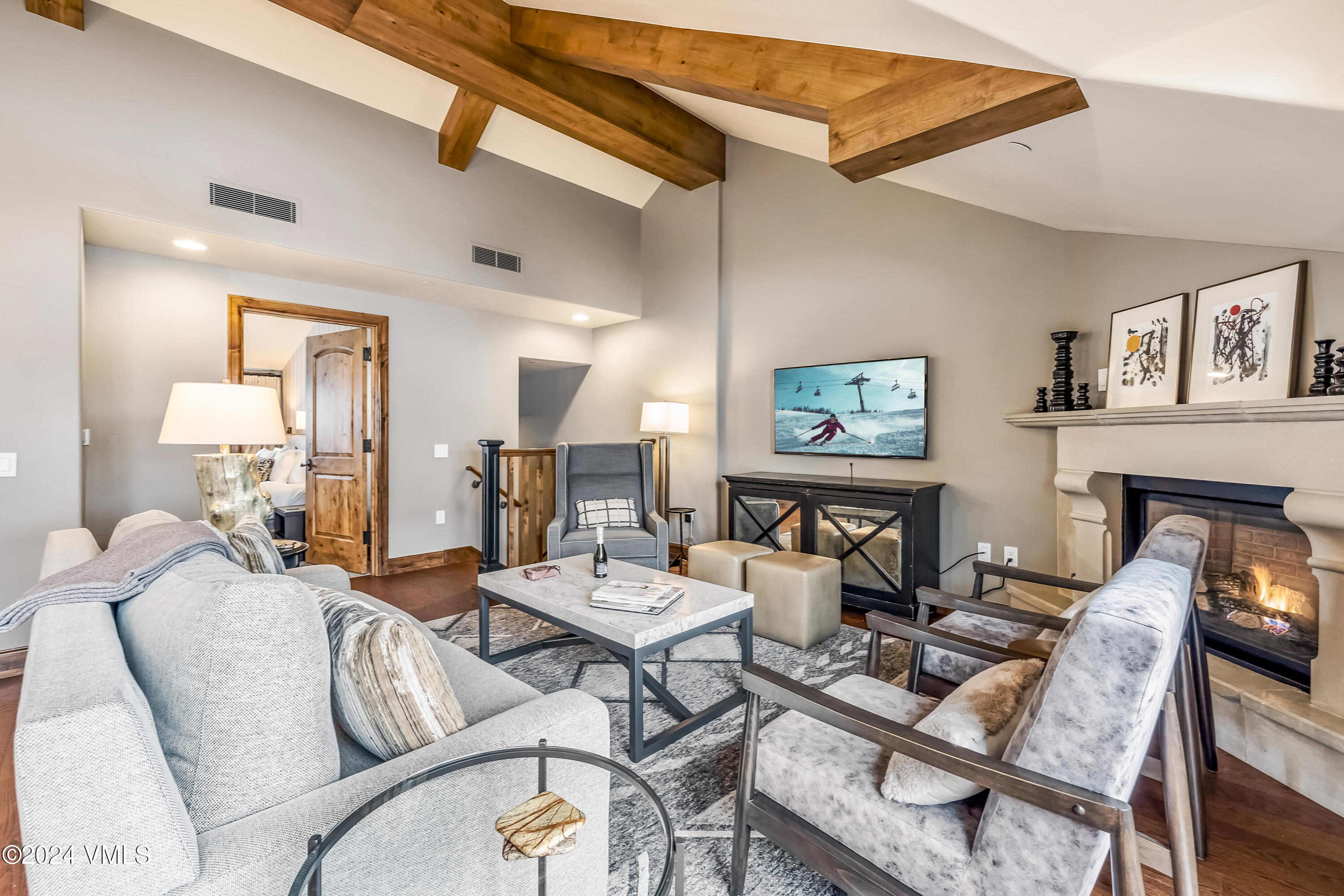 16 Vail Road Vail, CO 81657 - Photo 10 of 36 a living room with fireplace furniture and a wooden floor