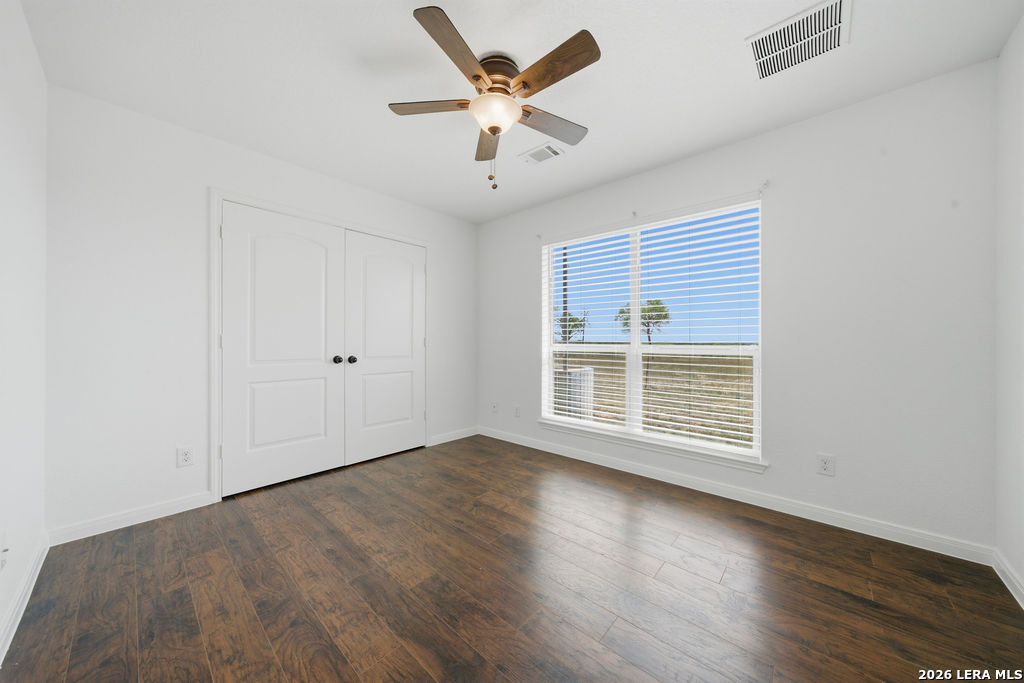 12897 La Vernia Road St. Hedwig, TX 78152 - Photo 23 of 34 an empty room with wooden floor and windows