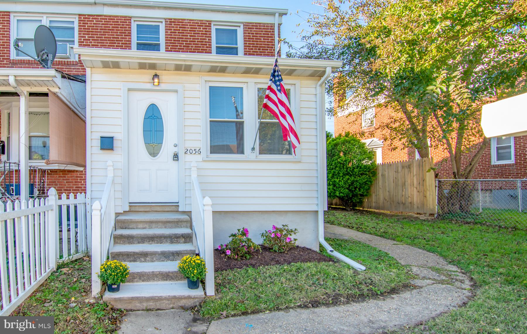 2056 Jasmine Road Dundalk, MD 21222 - Photo 2 of 30 a view of a brick house with a yard and plants