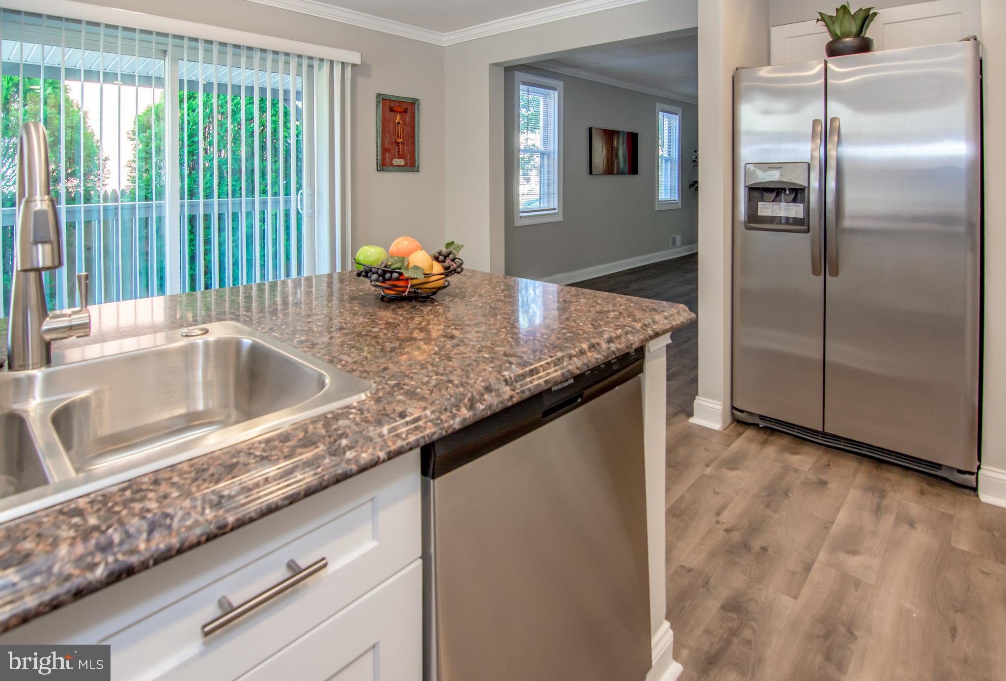 2056 Jasmine Road Dundalk, MD 21222 - Photo 15 of 30 a kitchen with granite countertop a refrigerator and a sink