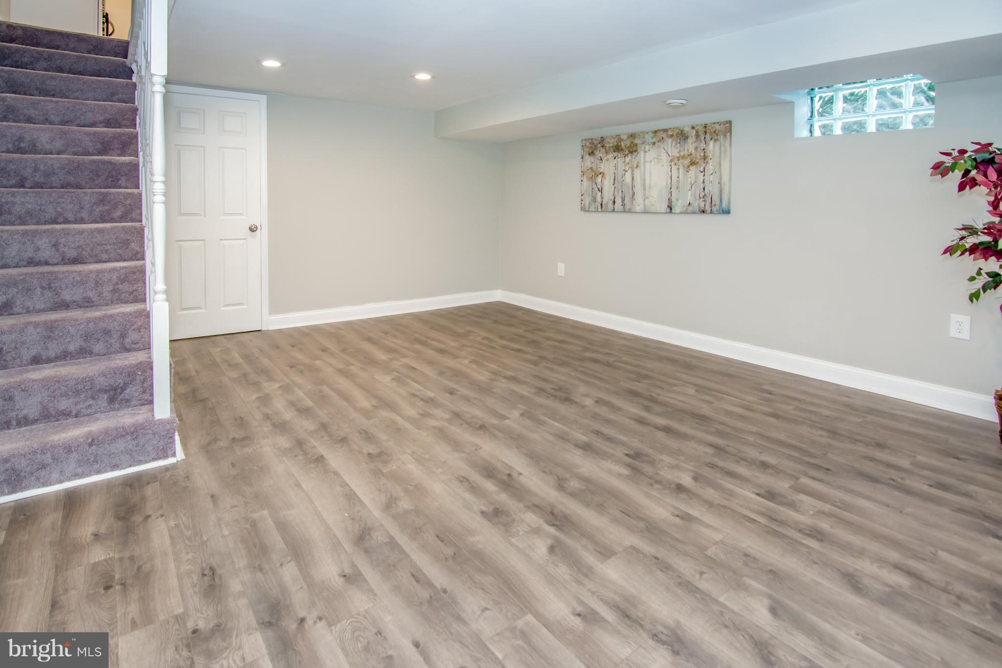 2056 Jasmine Road Dundalk, MD 21222 - Photo 19 of 30 an empty room with wooden floor and windows