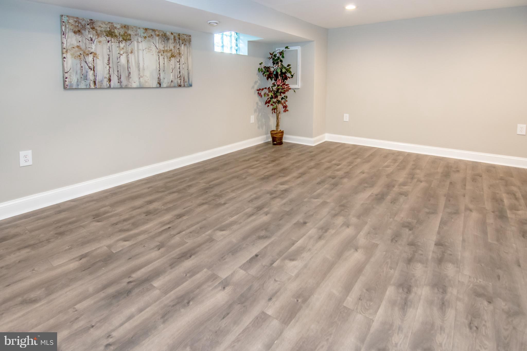 2056 Jasmine Road Dundalk, MD 21222 - Photo 20 of 30 a view of a big room with wooden floor and potted plants