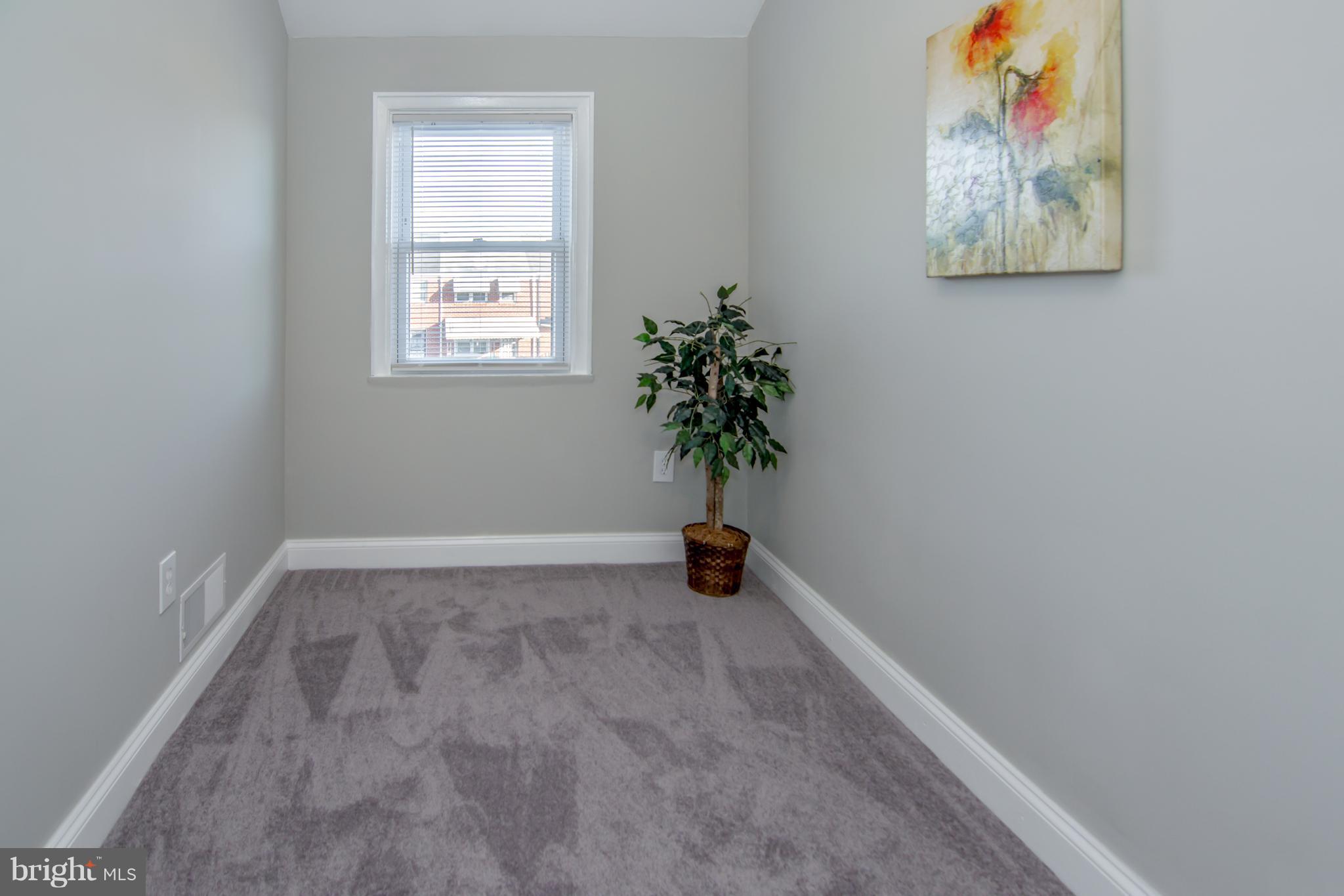 2056 Jasmine Road Dundalk, MD 21222 - Photo 29 of 30 a view of an empty room with a window and a potted plant