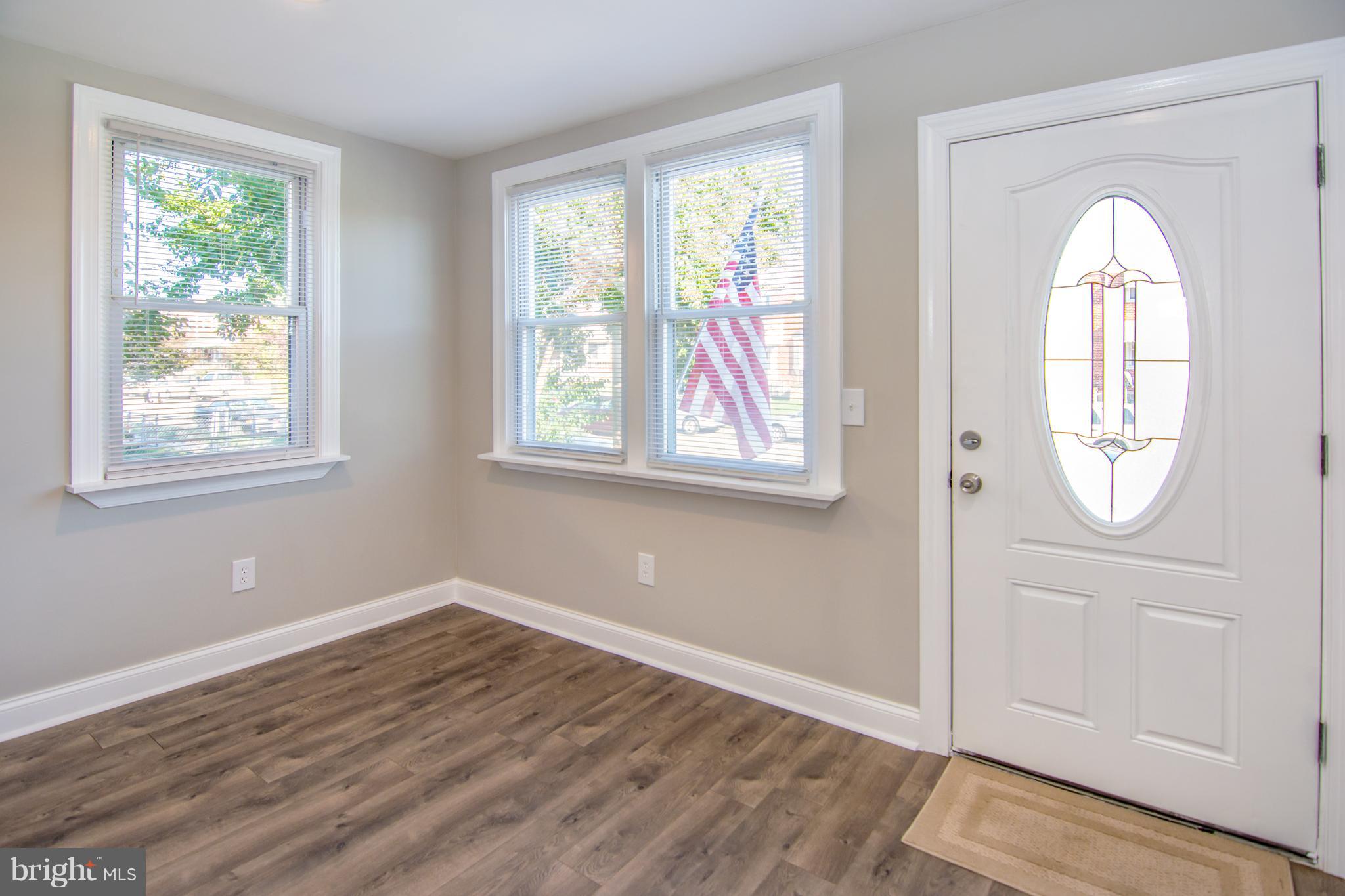 2056 Jasmine Road Dundalk, MD 21222 - Photo 9 of 30 an empty room with wooden floor and windows