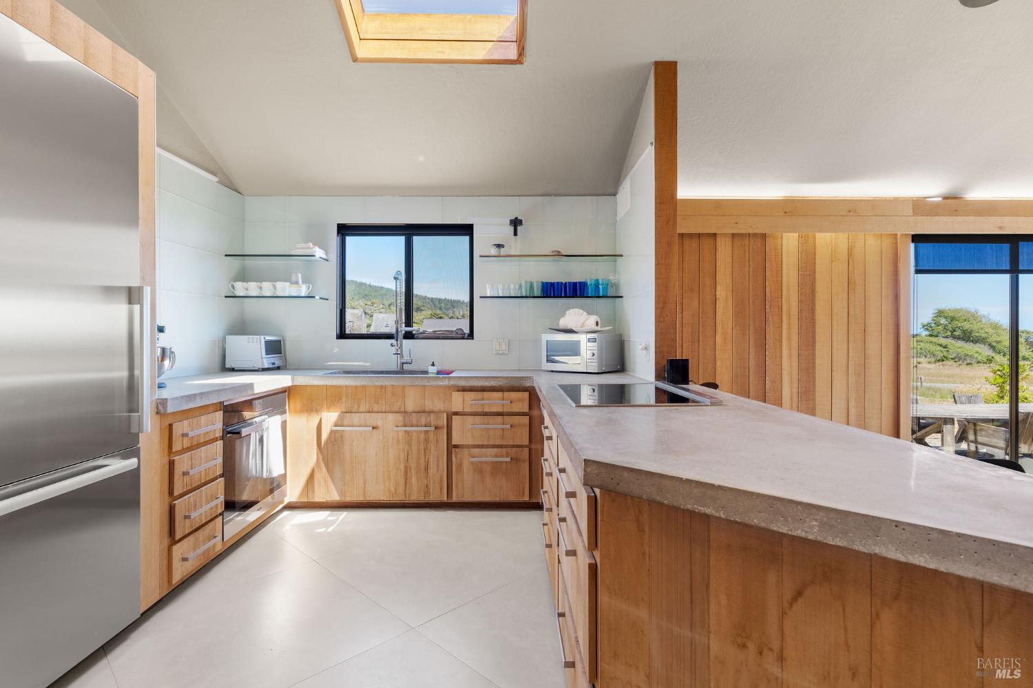 39412 Pacific Reach The Sea Ranch, CA 95497 - Photo 6 of 31 a kitchen with stainless steel appliances granite countertop a sink refrigerator and cabinets