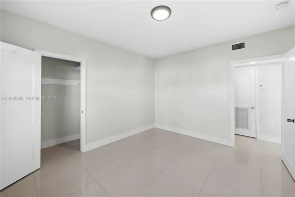 an empty room with closet area