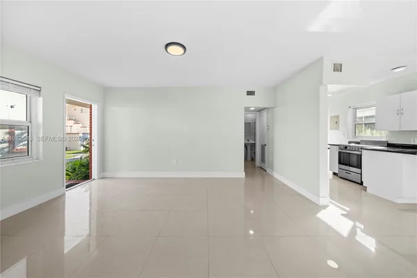 a view of a kitchen with a sink and a window