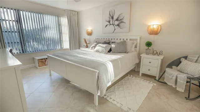 a bedroom with a bed and a painting on the wall