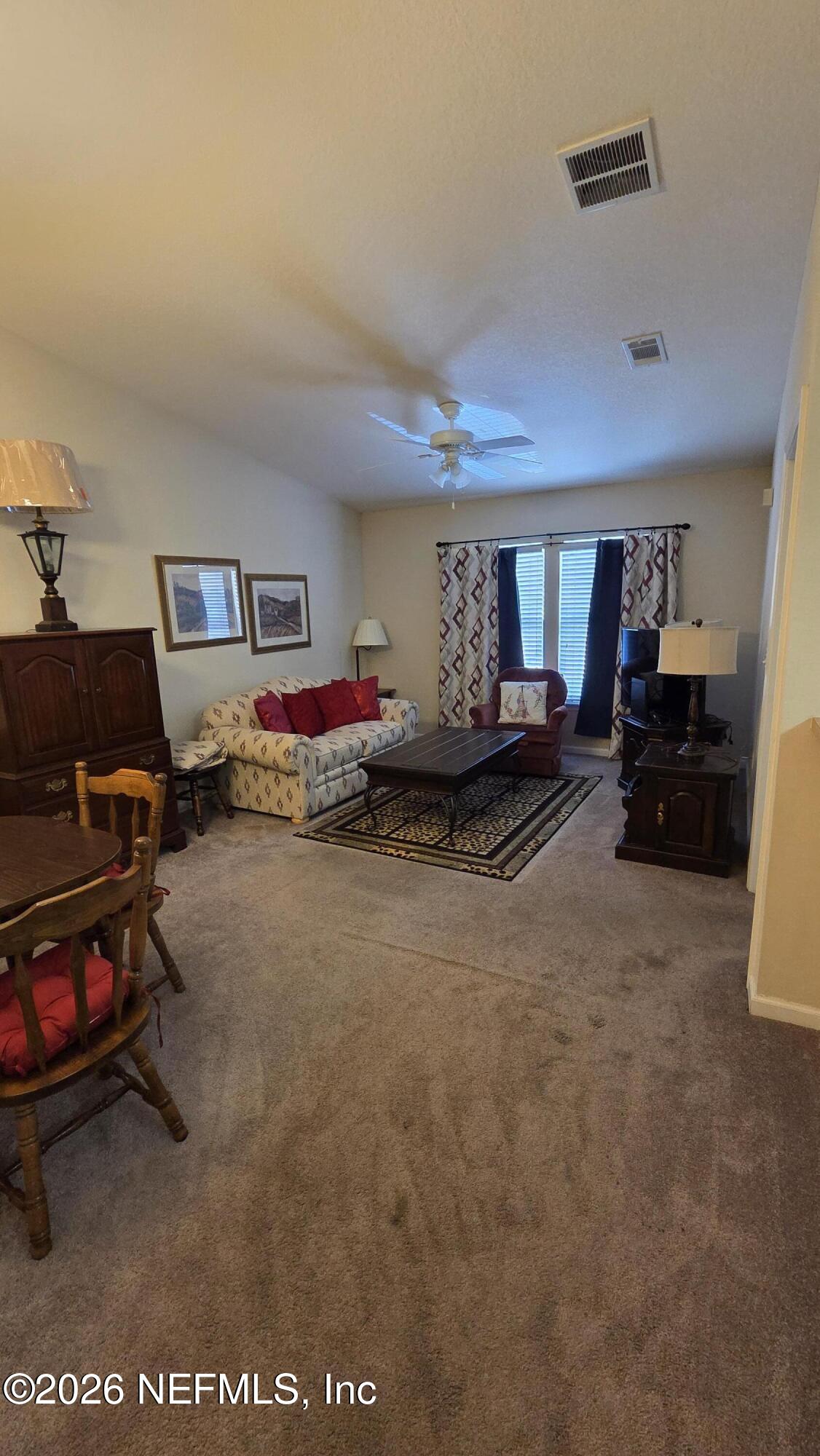 9400 Underwing Way, Unit 9 Jacksonville, FL 32257 - Photo 16 of 30 a living room with furniture flat screen tv and a lamp