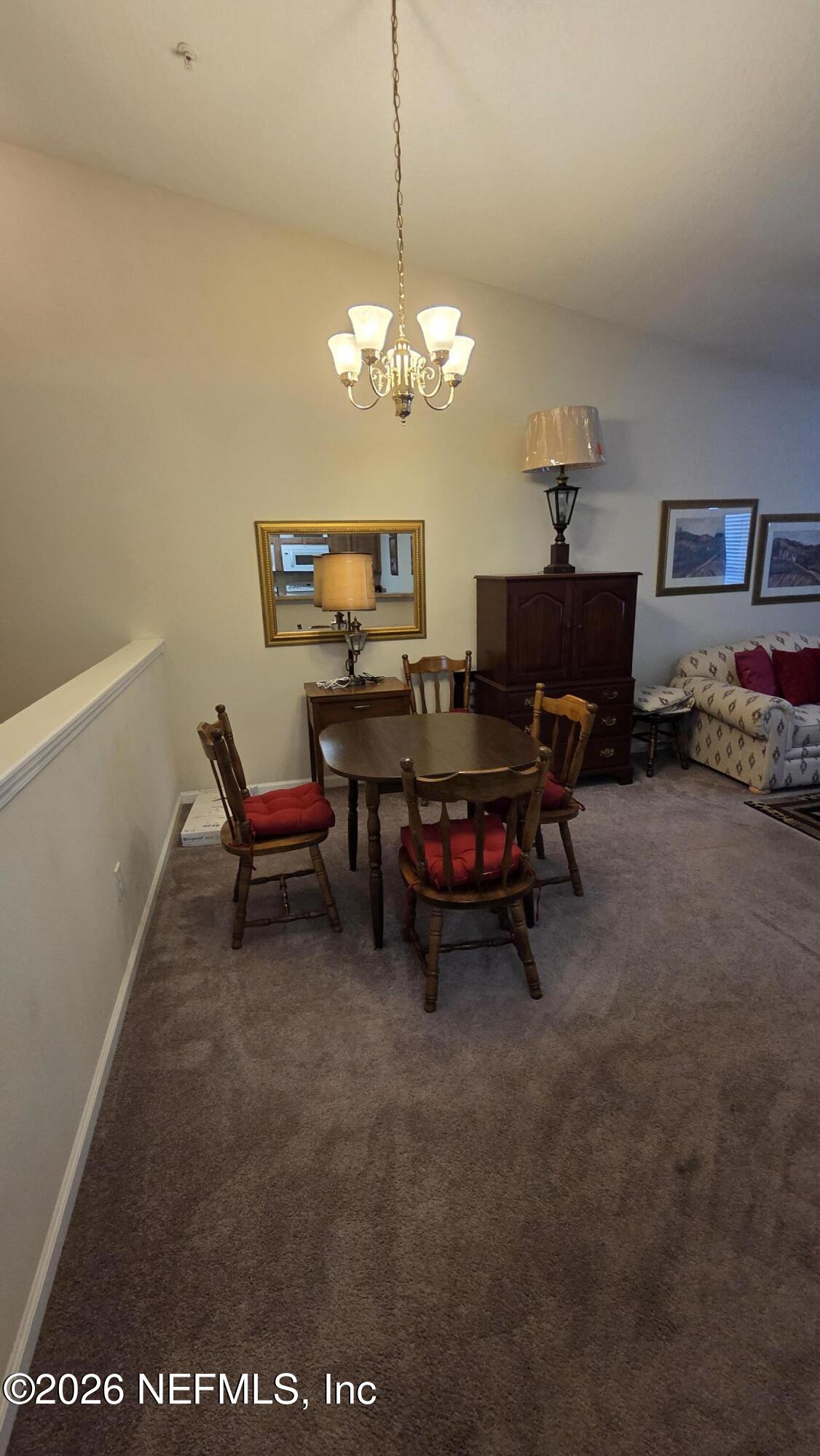 9400 Underwing Way, Unit 9 Jacksonville, FL 32257 - Photo 17 of 30 a view of a livingroom with furniture and a chandelier