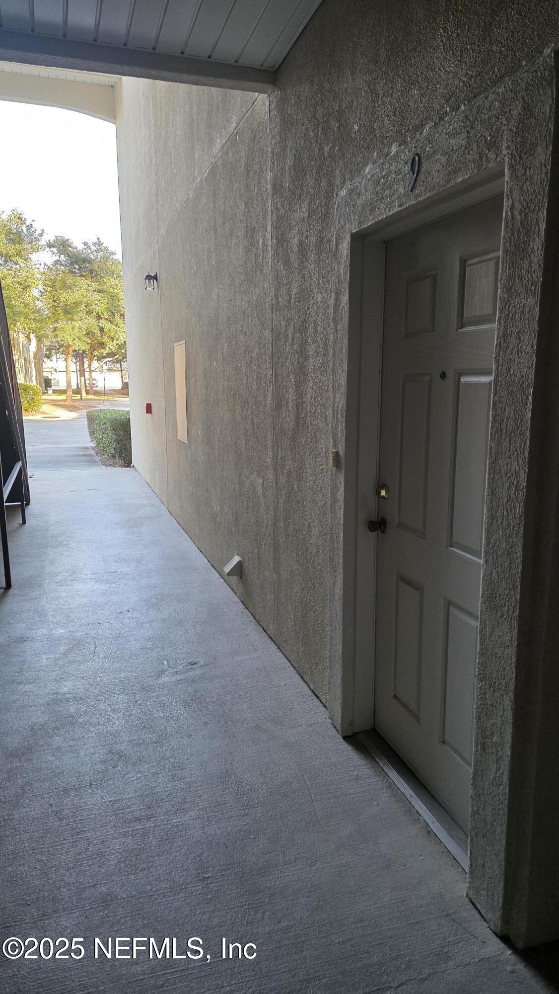 9400 Underwing Way, Unit 9 Jacksonville, FL 32257 - Photo 2 of 30 a view of hallway with wooden floor and windows