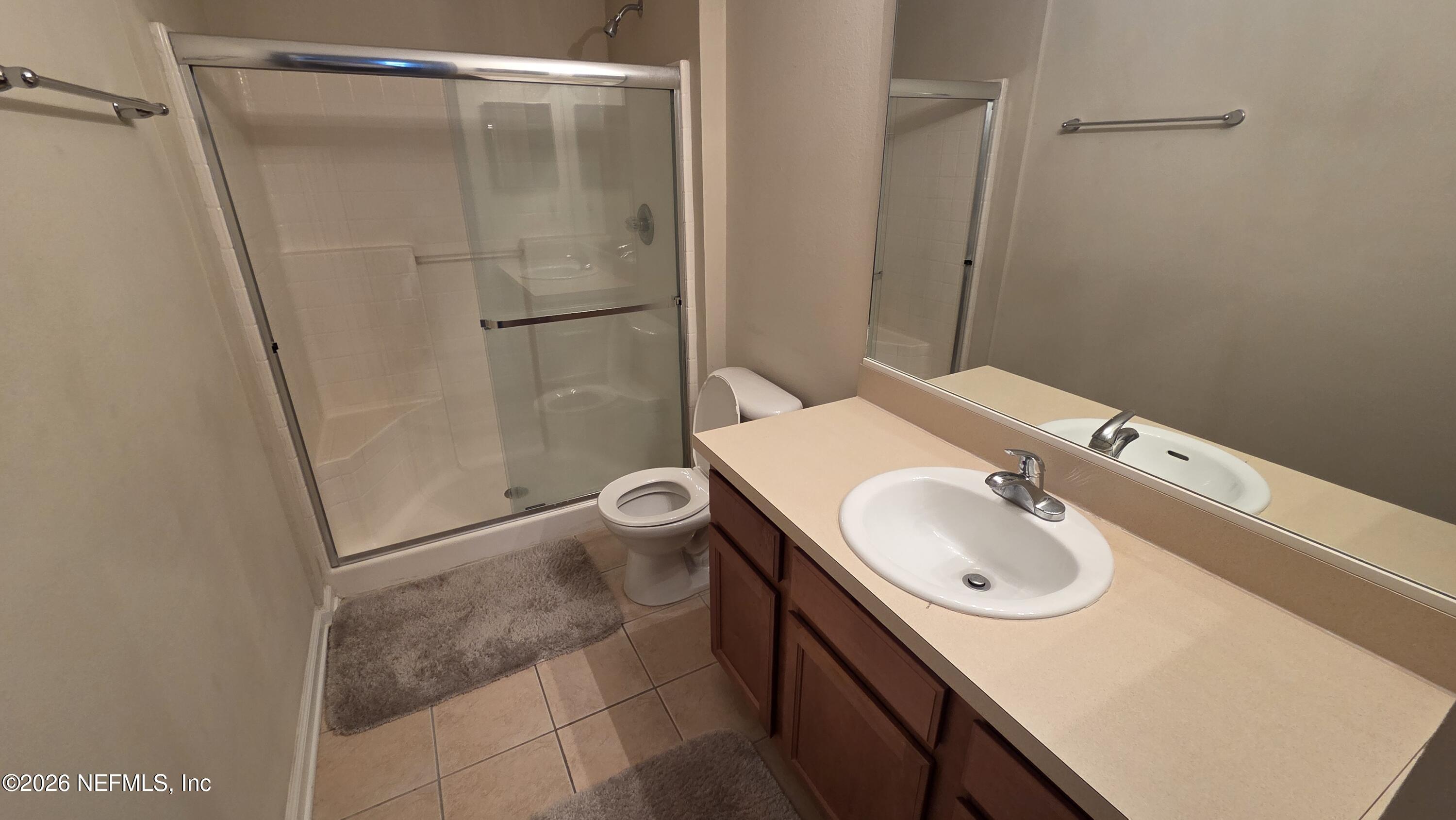 9400 Underwing Way, Unit 9 Jacksonville, FL 32257 - Photo 25 of 30 a bathroom with a sink and mirror