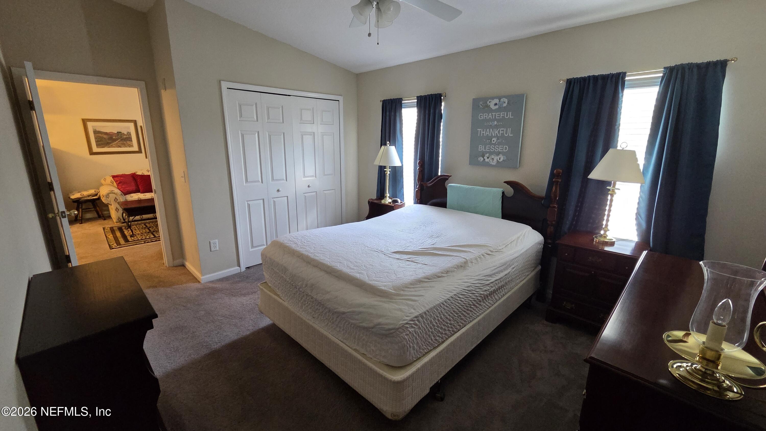 9400 Underwing Way, Unit 9 Jacksonville, FL 32257 - Photo 27 of 30 a bedroom with a bed and dresser with mirror