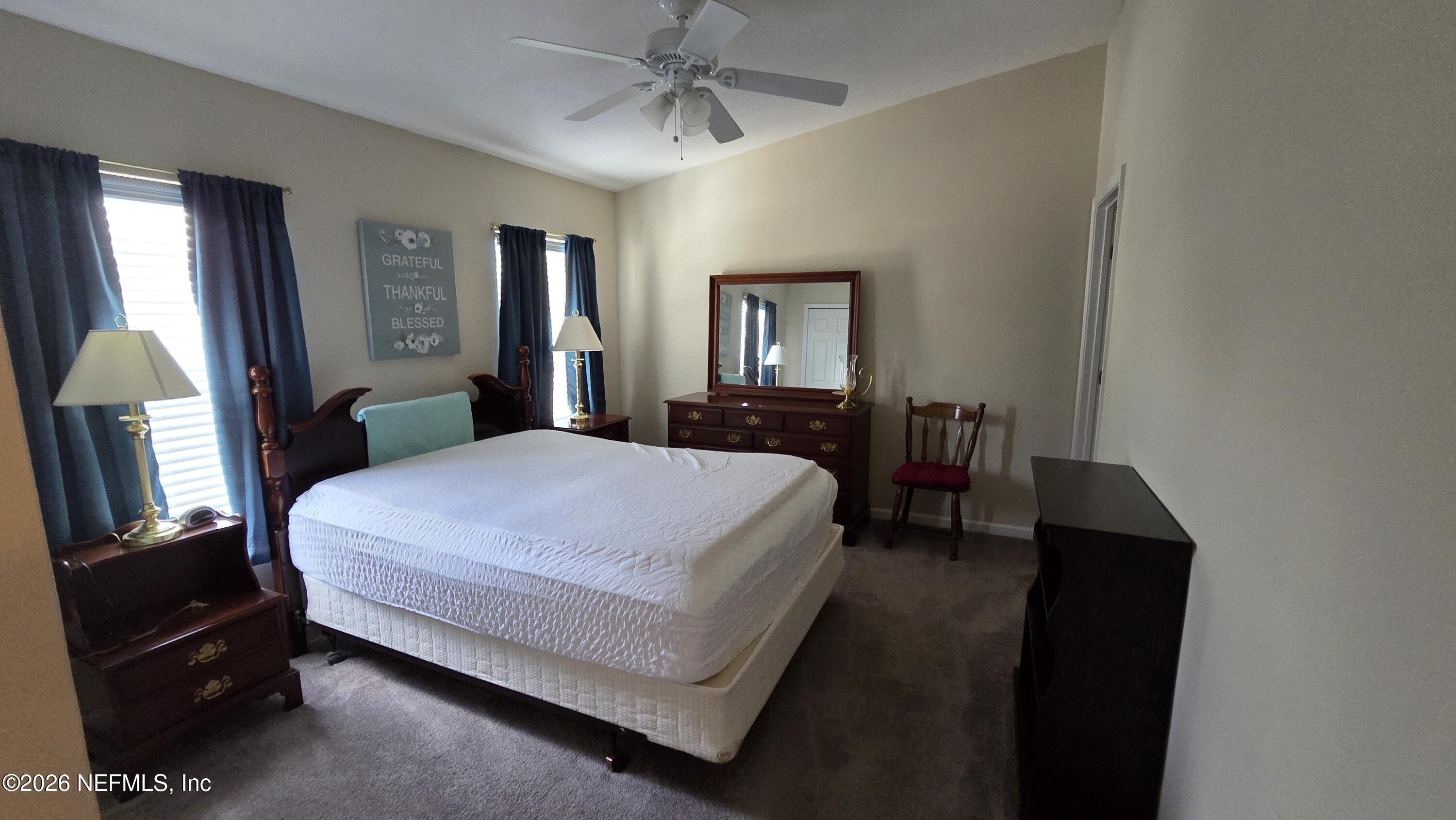 9400 Underwing Way, Unit 9 Jacksonville, FL 32257 - Photo 28 of 30 a bed room with a bed and a mirror