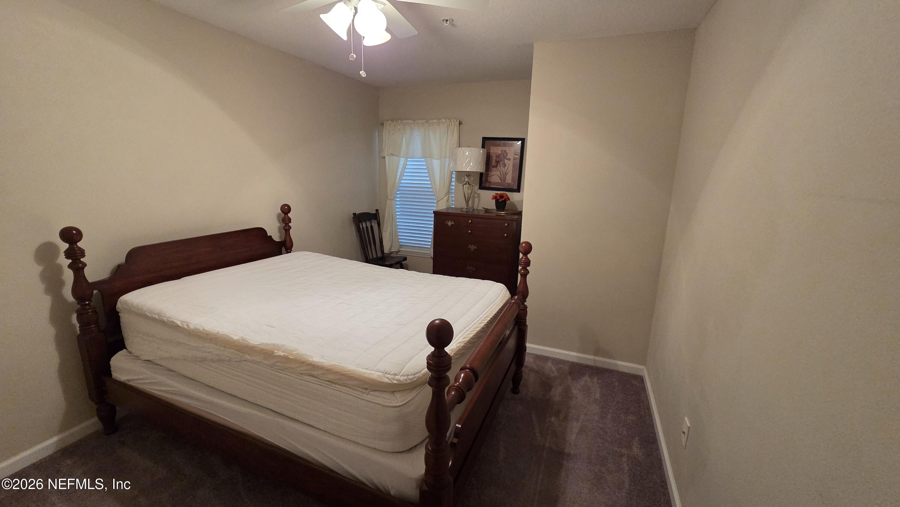 9400 Underwing Way, Unit 9 Jacksonville, FL 32257 - Photo 30 of 30 a bed sitting in a bedroom and chair