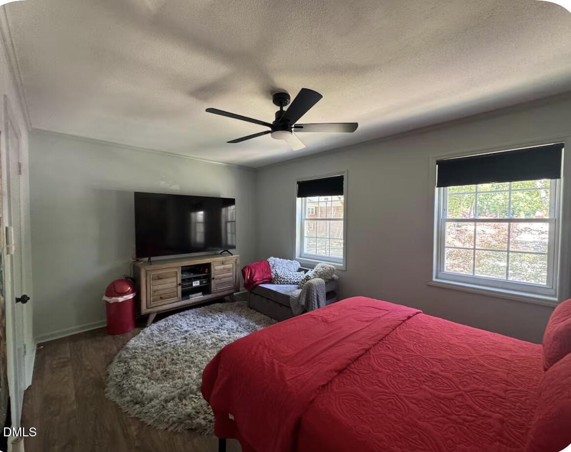 6369 New Market Way Raleigh, NC 27615 - Photo 10 of 14 a bedroom with a bed and a flat screen tv