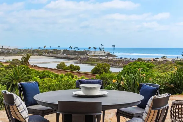 a view of a patio with furniture and a lake view