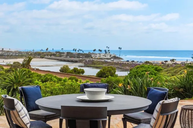 a view of a patio with furniture and a lake view