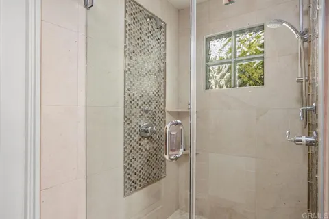 a bathroom with a shower and a window